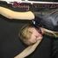Watching sexy SANDRA wearing sexy black shiny nylon rainwear being tied and gagged overhead with ropes and a ballgag being treated with the massager (Pics)