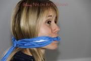 Samantha tied and gagged on bed wearing shiny nylon rainwear (Pics)