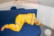 Archive girl tied and gagged by using tape on a sofa wearing an yellow rainsuit (Pics)