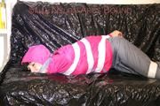 Mara tied, gagged and hooded with tape on a sexy black covered sofa wearing a supersexy grey rain pants and a pink rain jacket (Pics)