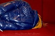 Samantha bound and gagged in a shiny nylon down coat