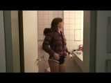 Alina wearing a jeans over a sexy shiny nylon shorts and a purple down jacket strolling on a lake (Video)