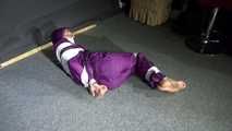 Sexy Sandra wearing a supersexy purple shiny nylon rainsuit bein tied and gagged and hooded on the floor with tape (Video)