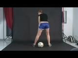 Archive girl posing with a soccer ball wearing a sexy blue shiny nylon shorts and a top (Video)