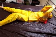 Pia tied and gagged in a shiny nylon rainsuit 