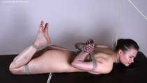 Nude barefoot Peggy, hogtied with hemp rope, is getting breathplayed by the man