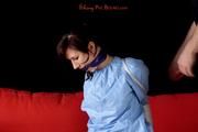 Julia tied and gagged in a shiny PVC suit
