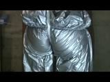 a video with Nicole tied and gagged in a shiny silver PVC sauna suit