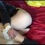 Lucy tied and gagged on bed wearing a sexy black shiny nylon shorts and a black rain jacket (Video)