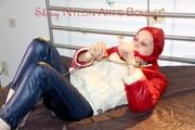 Lucy tied and gagged by herself on a bed wearing a sexy blue shiny nylon rainpants and an oldschool downjacket (Pics)