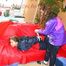 Leonie tied and gagged by Stella on a sofa both wearing sexy shiny nylon rainwear (Pics)