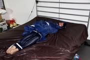 Simone tied and gagged in a shiny nylon rainsuit and a shiny nylon cape