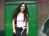 029013 Robyn Pees Behind A Parked Car In The Busy Shopping Street