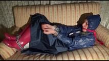 Mara tied, gagged and hooded on an old sofa wearing a cool blue rain skirt and a jacket as well as rubber boots (Video)