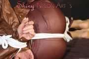 Watching sexy Sonja being tied and gagged on a bed with ropes and a clothgag wearing a supersexy shiny brown nylon pants and a brown rain jacket (Pics)