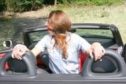 Stella tied and gagged in a grey shiny nylon catsuit in a car