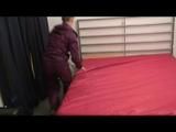 Jenny preparing her bed and lolling in bed wearing sexy purple shiny nylon rainwear (Video)