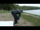 Enni wearing shiny nylon shorts and a rain jacket as well as a rain pants over the shorts (Video)