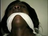 BLACK BANK TELLER IS MOUTH STUFFED, CLEAVE GAGGED & ROPE TIED TO CHAIR  (D46-2)