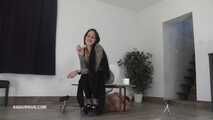 Mistress Cleo squirts cologne into the mouth of the slave lying in the toilet.