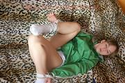 Leonie tied and gagged on a sofa wearing a sexy green shiny nylon shorts and a green rain jacket (Pics)