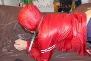 Jill tied, gagged and hooded with a pillory and cuffs wearing sexy shiny nylon rainwear (Pics)