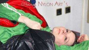 Lucy wearing sexy green shiny nylon shorts and a green rain jacket lolling on bed with a special cover (Pics)