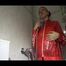 Mara wearing a very special red rain jacket and a darkblue rain pants enjoying herself and the cloths during taking a shower in it (Video)
