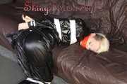 Sexy Courtney being tied and gagged with tape on a bed wearing black rainwear (Pics)