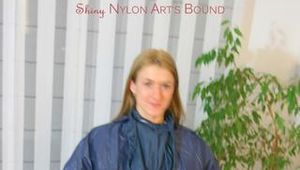 one of our archive girls tied and gagged in shiny nylon rainwear