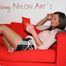Alina lolling on a sofa wearing a sexy black shiny nylon shorts and a white top (Pics)