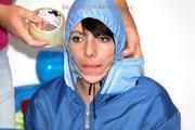 Simone tied and gagged in a shiny nylo skisuit