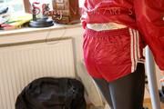 Mara wearing a red shiny nylon shorts, a black shiny leggins and a red rain jacket doing her workout (Pics)