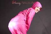 Mara wearing a sexy pink rainsuit posing infront of the camera in a studio (Pics)
