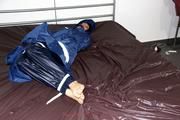 Simone tied and gagged in a shiny nylon rainsuit and a shiny nylon cape