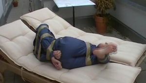 a video with one of our archive girls tied and gagged in a shiny nylon rainsuit