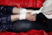 Sexy Courtney being tied and gagged with ropes and a ballgag on a bed wearing dark blue rainwear (Pics)
