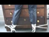 03:00 Min. video with Shelly tied and gagged in shiny nylon rainwear