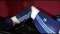 Lucy tied, gagged and hooded on a sofa with tape wearing a sexy blue rainwear combination (Video)