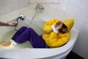 Julia tied and gagged in a ski suit in the bath tub