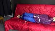 SANDRA being tied and gagged on a sofa with ropes and a clothgag wearing a sexy blue shiny nylon rain pants and a purple rain jacket  (Video)