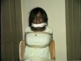 BLACK BANK TELLER IS MOUTH STUFFED, CLEAVE GAGGED & ROPE TIED TO CHAIR  (D46-2)