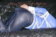 ***SEXY SANDRA*** wearing a supersexy skinny shiny nylon pants and a lightblue shiny nylon rain jacket being bound on a sofa with ropes and a ball gag (Pics)