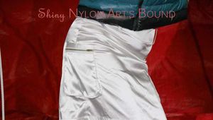 Sonja tied and gagged over her head on the arms wearing a sexy white shiny nylon skirt and a green down jacket (Pics)