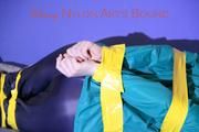 Mara tied and gagged with tape on a sofa wearing a supersexy shiny blue rain pants and a grren rain jacket (Pics) 