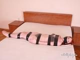 [From archive] Liska mummified in clear cling film with black duct tape