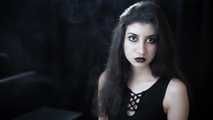 Goth girl with black eyes occasionally prefers dragging a 120mm cigarette