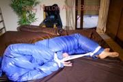 Jill tied, gagged and hooded on bed wearing a supersexy supershiny lightblue downwear (Pics)