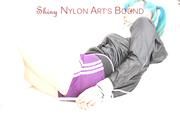 Mara tied and gagged on a white sofa in a reading lounge wearing a sexy purple shorts with shadow stripes and a black rain jacket (Pics)