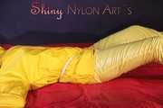Watching sexy Pia being tied and gagged with ropes on a bed and a clothgag wearing sexy yellow shiny nylon rainwear (Pics)